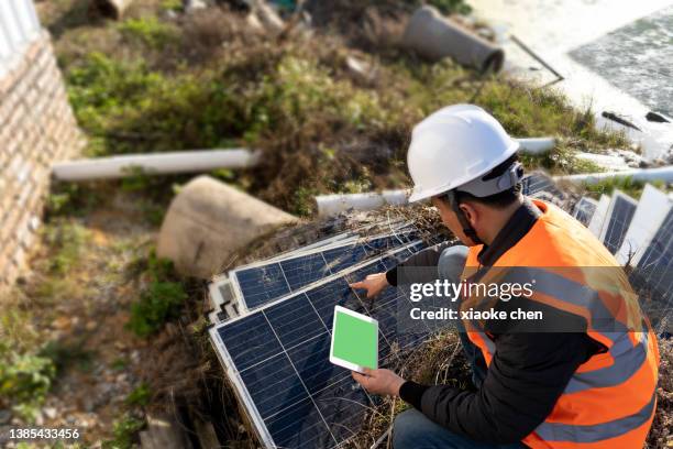 male engineer inspecting damaged solar panel - energy solutions stock pictures, royalty-free photos & images