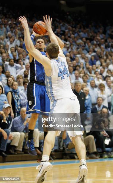 Austin Rivers of the Duke Blue Devils shoots the game-winning 3 pointer over Tyler Zeller to defeat the North Carolina Tar Heels 85-84 during their...