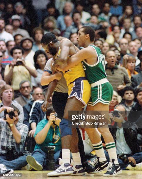 James Worthy and Dennis Johnson lock arms during 1985 NBA Finals between Los Angeles Lakers and Boston Celtics, June 2, 1985 in Inglewood, California.
