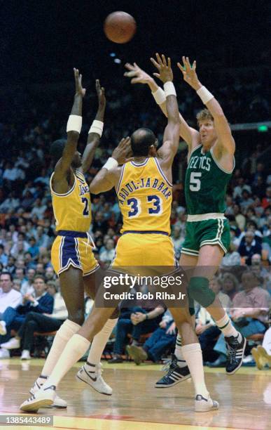 Boston Celtics Bill Walton passes the ball over Kareem Abdul-Jabbar and Michael Cooper during 1985 NBA Finals between Los Angeles Lakers and Boston...