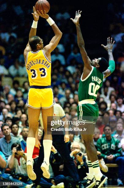 Lakers Kareem Abdul-Jabbar shoots over Celtics Robert Parish during 1985 NBA Finals between Los Angeles Lakers and Boston Celtics, June 2, 1985 in...