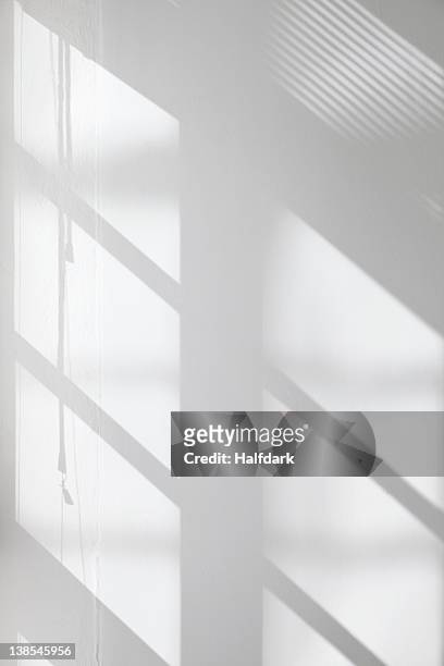 window glass, blinds and pulley shadows on wall - reflection photos et images de collection