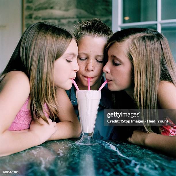 three friends sharing a malt - cute teens stock pictures, royalty-free photos & images