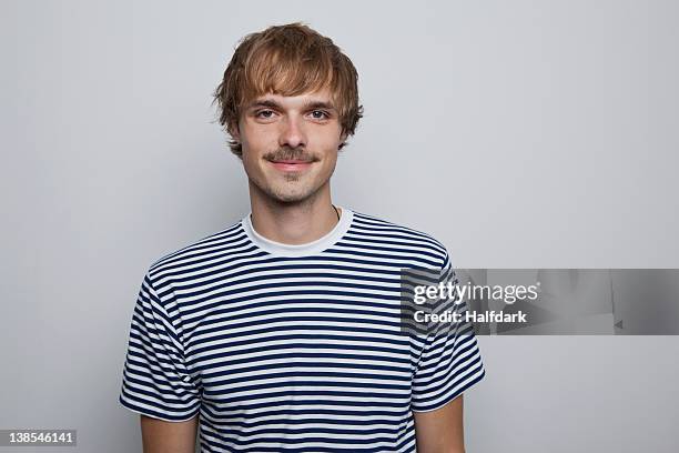 a young, hip man in a striped t-shirt - moustaches stockfoto's en -beelden
