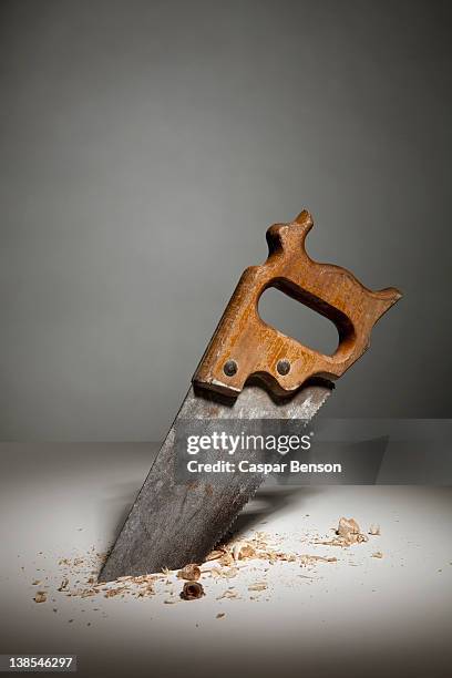 a saw sawing through wood - sawing stock pictures, royalty-free photos & images