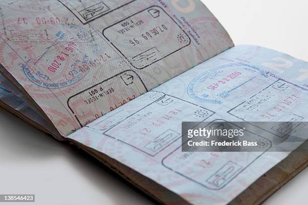 a united states passport with various country stamps - old book pages stock pictures, royalty-free photos & images
