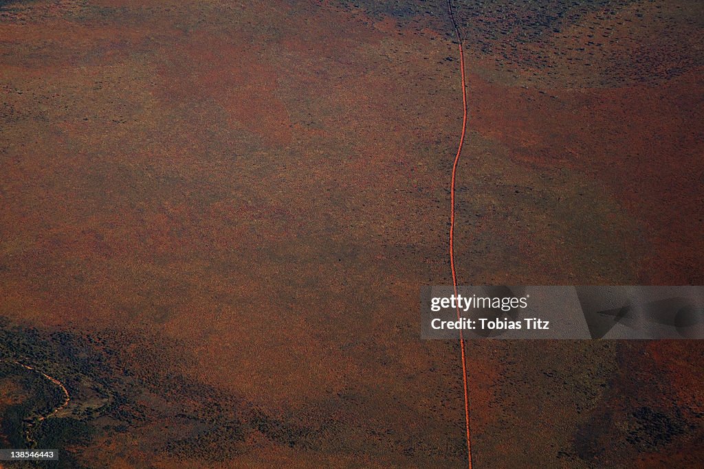 Aerial view of a dirt road positioned in a remote landscape