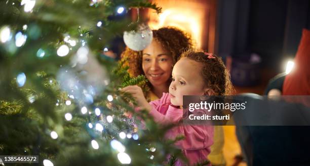 christmas tree decorating - decorating the christmas tree stock pictures, royalty-free photos & images