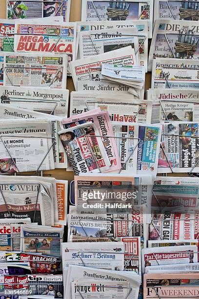 racks of german and international newspapers - news stand stock pictures, royalty-free photos & images