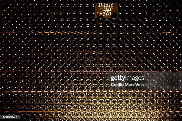 full stack of champagne bottles - cave vin photos et images de collection