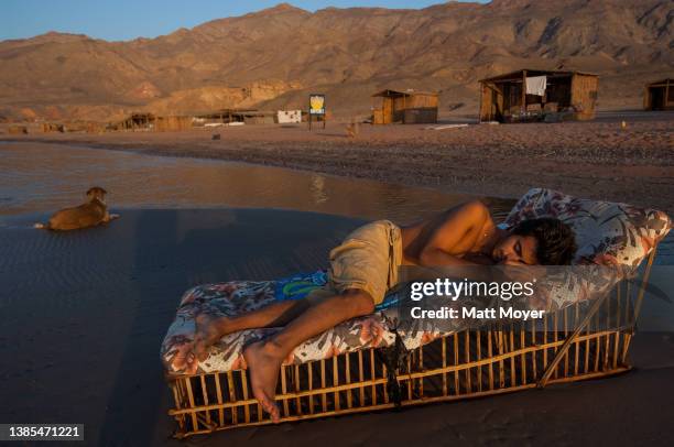 Itay Turgeman, of Telaviv, Israel, lies on a cot on a small sand island in the Gulf of Aquba near Nuweiba, Egypt on July 24, 2007.