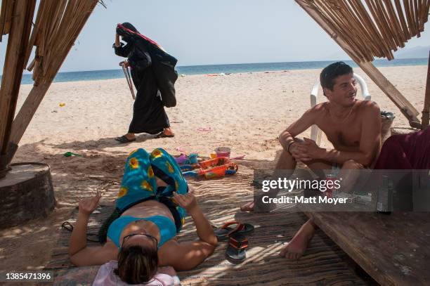 Tourists enjoy the beach while vacationing at camp Bawaki near the city of Nuweiba in the Sinai, Egypt on April 27, 2008.
