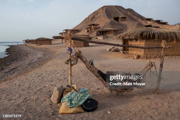 Tourists snoozes on an hammock while vacationing at camp Ras Shitan during the Passover holiday on April 26, 2008 near the city of Nuweiba in the...