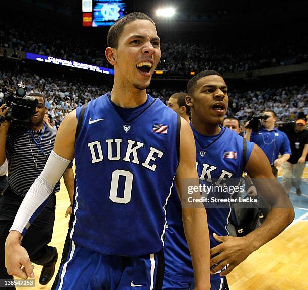 Austin Rivers of the Duke Blue Devils celebrates with teammate Quinn Cook after hitting a game-winning 3 pointer to defeat the North Carolina Tar...