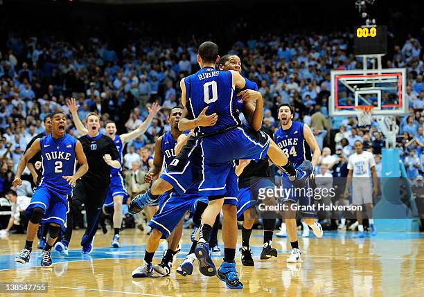 Teammates congratulate Austin Rivers of the Duke Blue Devils after his last-second game-winning three point basket against the North Carolina Tar...