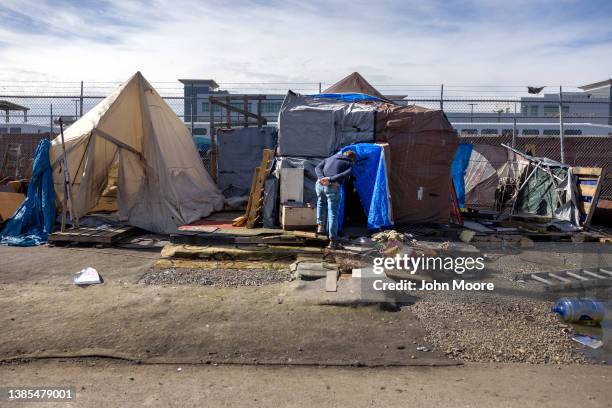 Kevin Dahlgren visits an encampment to speak with residents about moving to a homeless shelter on March 12, 2022 in Seattle, Washington. Dahlgren, a...