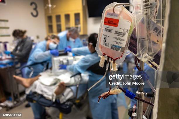 Medical personnel treat a multiple gunshot victim in the emergency room of Harborview Medical Center on March 09, 2022 in Seattle, Washington....