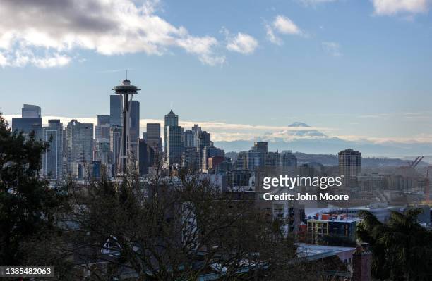 The Space Needle stands over the Seattle skyline as Mt. Rainier is seen in the background on March 13, 2022 in Seattle, Washington. The iconic...