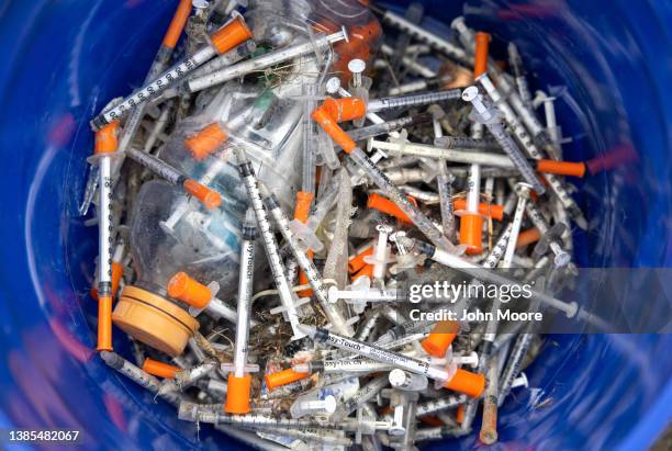 Heroin syringes fill a bucket after volunteers collected them at a homeless encampment on March 1, 2022 in Seattle, Washington. The non-profit We...