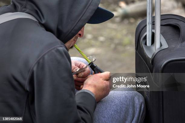 Homeless man smokes fentanyl on March 12, 2022 in Seattle, Washington. Widespread drug addiction is endemic in Seattle's large homeless community,...