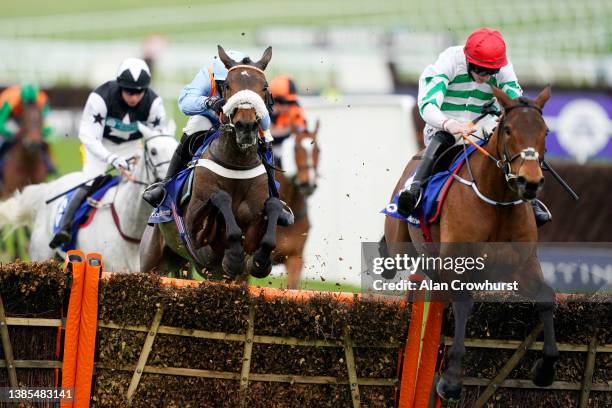 Nico de Boinville on Marie's Rock jumps the last hurdle to win The Mares’ Hurdle race before Jack Kennedy on Queens Brook during day one of the...