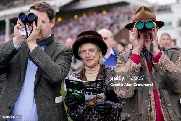 Racegoers watch the action from the lawns on day one of The Festival at Cheltenham Racecourse on March 15, 2022 in Cheltenham, England.