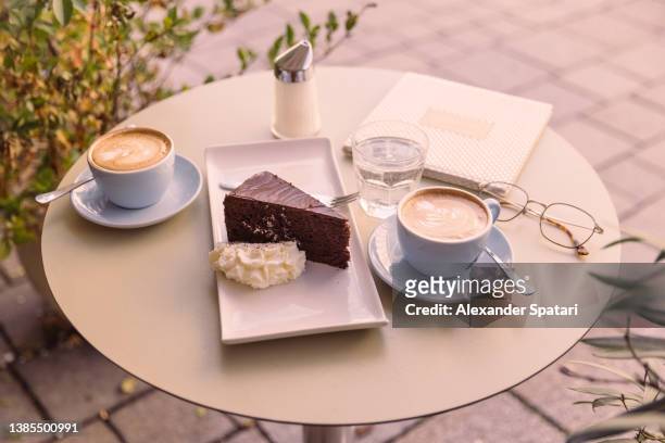 sacher torte served with coffee in a cafe in vienna, austria - sachertorte stock pictures, royalty-free photos & images