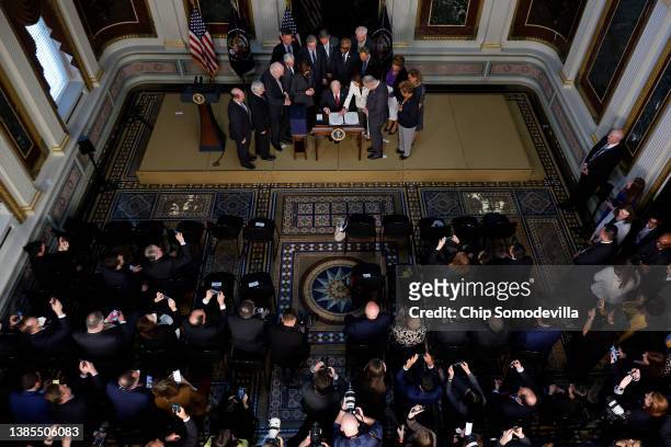 Speaker of the House Nancy Pelosi points to the place where U.S. President Joe Bidenis supposed to sign the “Consolidated Appropriations Act" in the...
