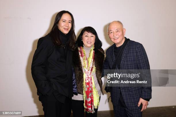 Designer William Fan poses with his parents at the William Fan Fashion Show during the Berlin Fashion Week March 2022 at Hamburger Bahnhof on March...