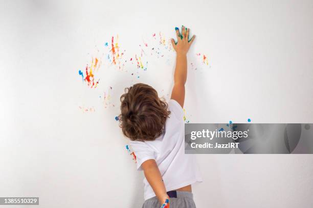 boy plays with finger paint - finger painting stock pictures, royalty-free photos & images