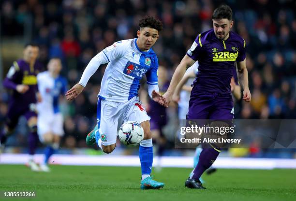 Tyrhys Dolan of Blackburn Rovers battles for possession with Eiran Cashin of Derby County during the Sky Bet Championship match between Blackburn...