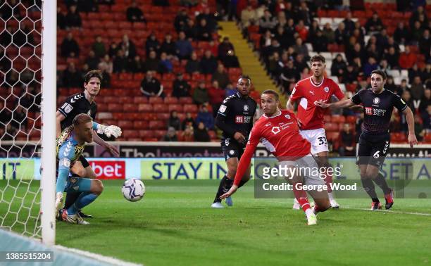Carlton Morris of Barnsley scores their side's first goal past Daniel Bentley of Bristol City during the Sky Bet Championship match between Barnsley...