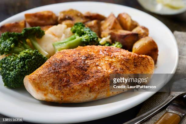 seasoned chicken breast with roasted potatoes - roast potatoes stock pictures, royalty-free photos & images