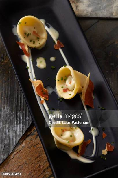 duck confit tortellini with celery root puree - confit stock pictures, royalty-free photos & images
