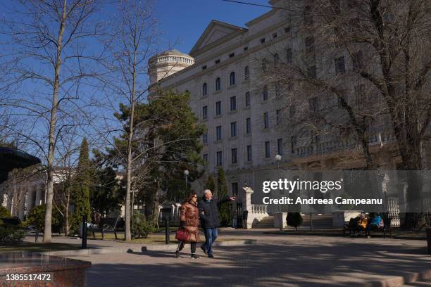 Couple passes in front of the OSCE building, on March 15, 2022 in Chisinau, Moldova. Spurred by Russia's invasion of Ukraine, Moldova applied for...