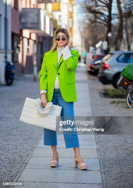 Victoria Scheu is seen wearing neon green blazer Zara, beige Plateau sandals Zara, Maternity Jeans h&m, bag Skergeth, knitted turtleneck during...