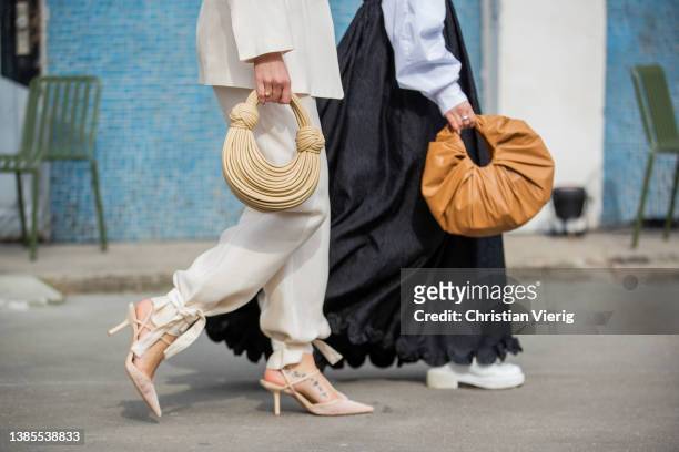 Tina Haase seen wearing creme white H&m circular innovation suit, beige Bottega Veneta Spaghetti Bag, heels & Amelie Stanescu seen wearing beige bag,...