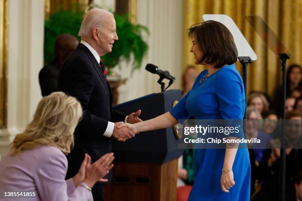 President Joe Biden pulls Iceland first lady Eliza Reid onto stage during an event celebrating Equal Pay Day in the East Room of the White House on...