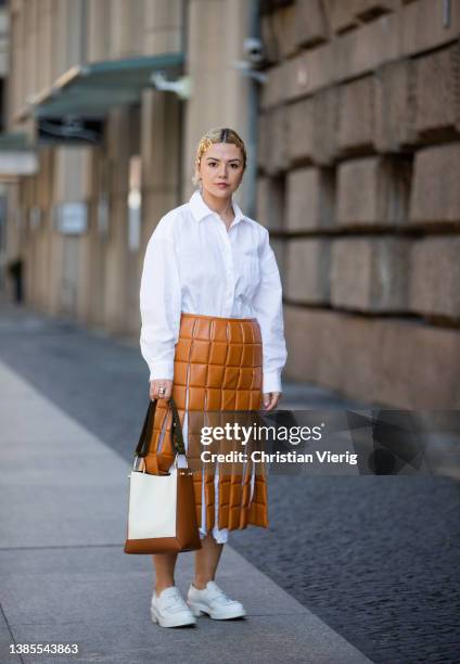 Amelie Stanescu seen with hair clips wearing white button shirt Arket, brown skirt awake mode, white loafers shoes Prada, two tone brown white bag...