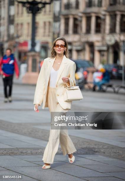 Mandy Bork is seen wearing beige suit NAKD, white bag Hermes, sunglasses Velha Eyewear, heeled sandals Jimmy Choo during Berlin Fashion Week on March...