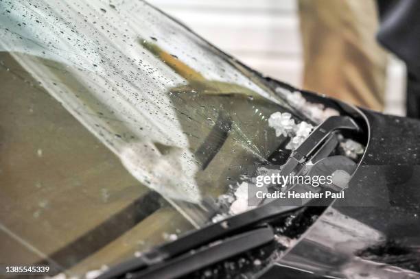 side view of  a car windshield shattered and damaged after a hail storm - hail stock-fotos und bilder