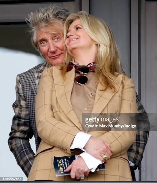 Sir Rod Stewart and Penny Lancaster watch the racing as they attend day 1 'Champion Day' of the Cheltenham Festival at Cheltenham Racecourse on March...