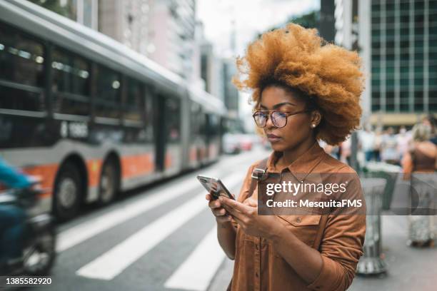 businesswoman at the bus stop - paulista avenue sao paulo stock pictures, royalty-free photos & images