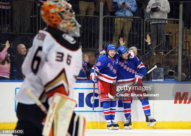 Adam Fox of the New York Rangers celebrates his game winning overtime goal against John Gibson of the Anaheim Ducks and is joined by Artemi Panarin...