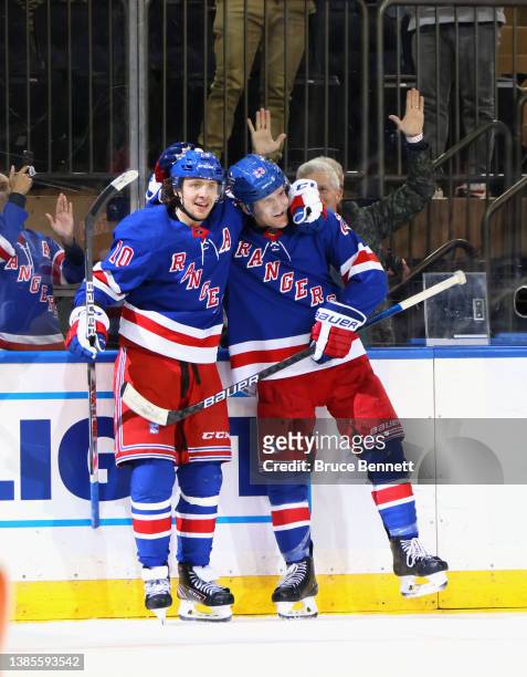 Adam Fox of the New York Rangers celebrates his game winning overtime goal against John Gibson of the Anaheim Ducks and is joined by Artemi Panarin...