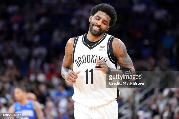 Kyrie Irving of the Brooklyn Nets reacts after scoring against the Orlando Magic in the second half at Amway Center on March 15, 2022 in Orlando,...