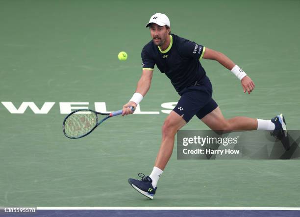 Steve Johnson of The United States plays a running forehand in his loss to Hubert Hurkacz of Poland during the BNP Parisbas Open at the Indian Wells...