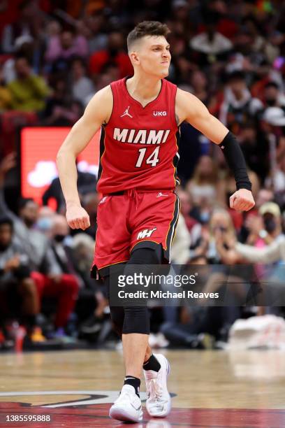 Tyler Herro of the Miami Heat celebrates a three pointer by Max Strus against the Detroit Pistons during the second half at FTX Arena on March 15,...
