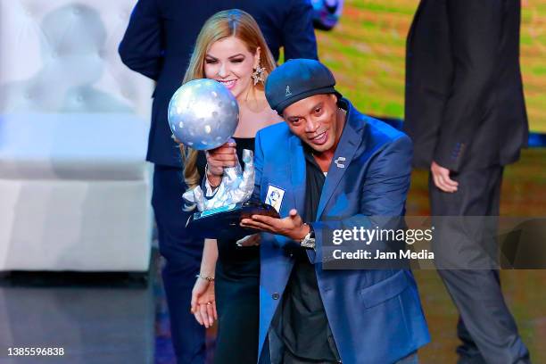 Ronaldinho poses with a trophy after getting into the hall of fame during the 10th International Soccer Hall Of Fame Induction Gala at Auditorio Gota...