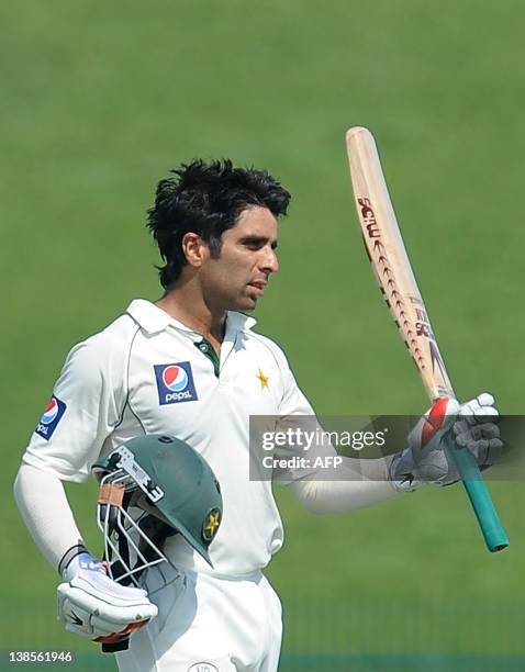 Pakistan's cricketer Taufiq Umar raises his bat to the crowd after scoring a half-century on the second day of the opening cricket Test between...